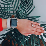 Ladies Sage Gray Double Wrap Apple Watch Leather Band by Juxli Home.  Handmade, stylish leather strap with rose gold hardware on a 40mm Apple watch on a canvas with a black and gray painting.