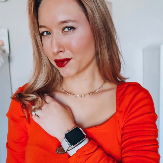 Ladies Sage Gray Double Wrap Apple Watch Leather Band by Juxli Home.  Handmade, stylish leather strap with rose gold hardware on a 40mm Apple watch on a canvas with a black and gray painting.