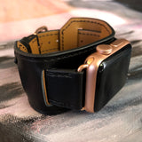 Black Apple Watch Leather Cuff by Juxli Home.  Handmade, stylish leather strap with rose gold hardware on a 40mm Apple watch on a canvas with a black and gray painting.