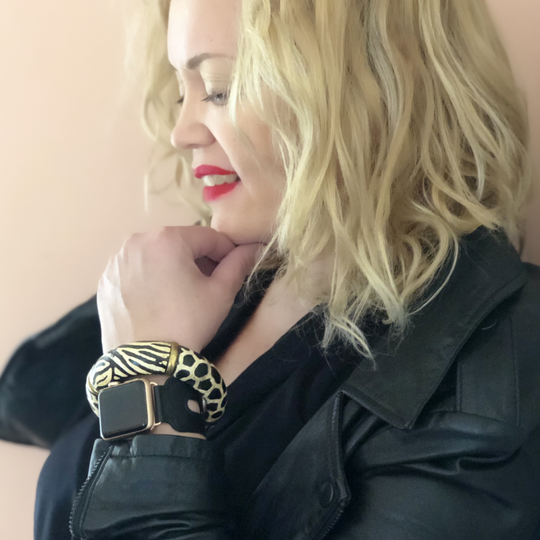 Black Double Buckle Apple Watch Leather Cuff by Juxli Home.  Handmade, stylish leather strap with rose gold hardware on a 40mm Apple watch on a canvas with a black and gray painting.