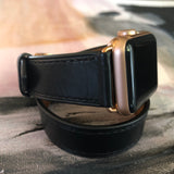Jet Black Double Wrap Apple Watch Leather Band by Juxli Home.  Handmade, stylish leather strap with rose gold hardware on a 40mm Apple watch on a canvas with a black and gray painting.