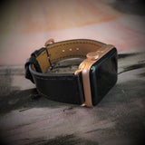 Black Apple Watch Leather Band by Juxli Home.  Handmade, stylish leather strap with rose gold hardware on a 40mm Apple watch on a canvas with a black and gray painting.