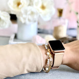 Blush Rose Apple Watch Leather Band by Juxli Home.  Handmade, stylish leather strap with rose gold hardware on a 40mm Apple watch on a canvas with a black and gray painting.