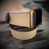 Blush Rose Double Wrap Apple Watch Leather Band for Women by Juxli Home.  Handmade, stylish leather strap with rose gold hardware on a 40mm Apple watch on a canvas with a black and gray painting.