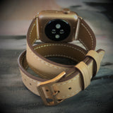 Blush Rose Double Wrap Apple Watch Leather Band for Women by Juxli Home.  Handmade, stylish leather strap with rose gold hardware on a 40mm Apple watch on a canvas with a black and gray painting.