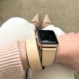 Blush Rose Double Wrap Apple Watch Leather Band for Women by Juxli Home.  Handmade, stylish leather strap with rose gold hardware on a 40mm Apple watch on a canvas with a black and gray painting.