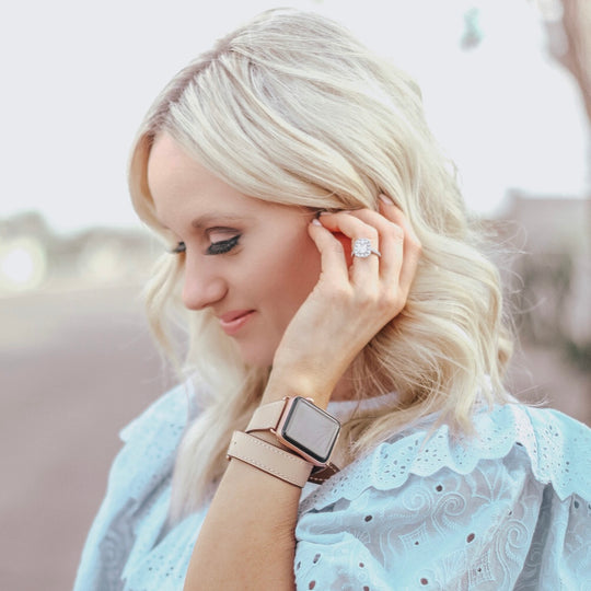 Blush Rose Double Wrap Apple Watch Leather Band for Women by Juxli Home.  Handmade, stylish leather strap with rose gold hardware on a 40mm Apple watch on a canvas with a black and gray painting.