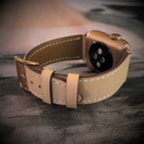 Blush Rose Apple Watch Leather Band by Juxli Home.  Handmade, stylish leather strap with rose gold hardware on a 40mm Apple watch on a canvas with a black and gray painting.