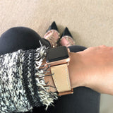 Blush Rose Apple Watch Leather Band by Juxli Home.  Handmade, stylish leather strap with rose gold hardware on a 40mm Apple watch on a canvas with a black and gray painting.