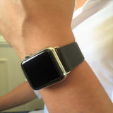 Charcoal Gray Apple Watch Leather Band by Juxli Home.  Handmade, stylish leather strap with rose gold hardware on a 40mm Apple watch on a canvas with a black and gray painting.