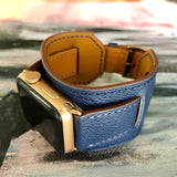Space Blue Apple Watch Leather Cuff by Juxli Home.  Handmade, stylish leather strap with rose gold hardware on a 40mm Apple watch on a canvas with a black and gray painting.
