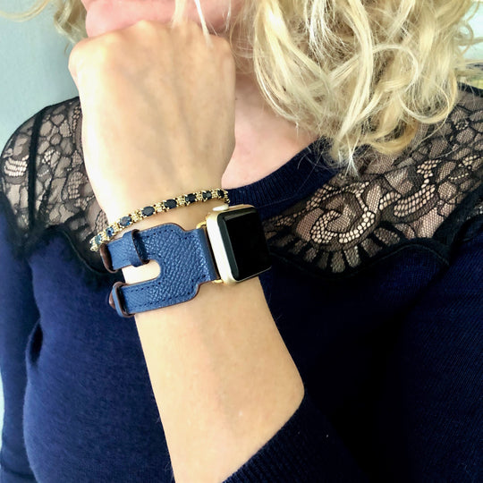 Space Blue Apple Watch Double Buckle Leather Cuff by Juxli Home.  Handmade, stylish leather strap with rose gold hardware on a 40mm Apple watch on a canvas with a black and gray painting.