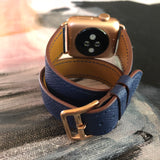 Space Blue Double Wrap Apple Watch Leather Band by Juxli Home.  Handmade, stylish leather strap with rose gold hardware on a 40mm Apple watch on a canvas with a black and gray painting.
