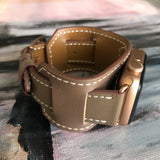 Hazel Brown Apple Watch Leather Cuff by Juxli Home.  Handmade, stylish leather strap with rose gold hardware on a 40mm Apple watch on a canvas with a black and gray painting.