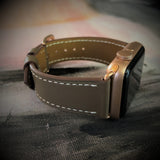 Hazel Brown Apple Watch Band by Juxli Home.  Handmade, stylish leather strap with rose gold hardware on a 40mm Apple watch on a canvas with a black and gray painting.