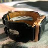 Black Double Buckle Apple Watch Leather Cuff by Juxli Home.  Handmade, stylish leather strap with rose gold hardware on a 40mm Apple watch on a canvas with a black and gray painting.