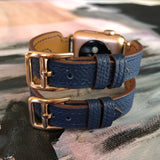 Space Blue Apple Watch Double Buckle Leather Cuff by Juxli Home.  Handmade, stylish leather strap with rose gold hardware on a 40mm Apple watch on a canvas with a black and gray painting.