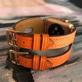 Summer Orange Double Buckle Apple Watch Leather Cuff by Juxli Home.  Handmade, stylish leather strap with rose gold hardware on a 40mm Apple watch on a canvas with a black and gray painting.