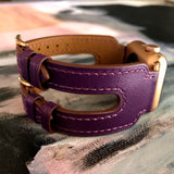 Rasin Purple Apple Watch Double Buckle Cuff by Juxli Home.  Handmade, stylish leather strap with rose gold hardware on a 40mm Apple watch on a canvas with a black and gray painting.