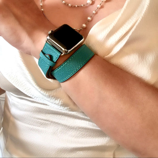Ladies Sea Green Double Wrap Apple Watch Leather Band by Juxli Home.  Handmade, stylish leather strap with rose gold hardware on a 40mm Apple watch on a canvas with a black and gray painting.