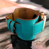 Sea Green Apple Watch Leather Cuff by Juxli Home.  Handmade, stylish leather strap with rose gold hardware on a 40mm Apple watch on a canvas with a black and gray painting.