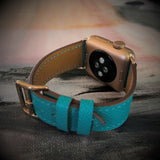 Sea Green Apple Watch Textured Leather Band by Juxli Home.  Handmade, stylish leather strap with rose gold hardware on a 40mm Apple watch on a canvas with a black and gray painting.