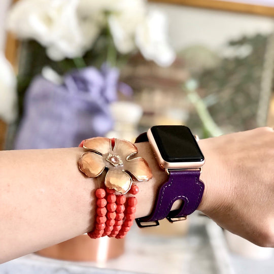Rasin Purple Apple Watch Double Buckle Cuff by Juxli Home.  Handmade, stylish leather strap with rose gold hardware on a 40mm Apple watch on a canvas with a black and gray painting.