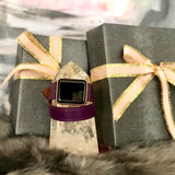 Rasin Purple Double Wrap Apple Watch Leather Band for Women by Juxli Home.  Handmade, stylish leather strap with rose gold hardware on a 40mm Apple watch on a canvas with a black and gray painting.
