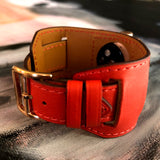 Fire Red Apple Watch Leather Cuff by Juxli Home.  Handmade, stylish leather strap with rose gold hardware on a 40mm Apple watch on a canvas with a black and gray painting.