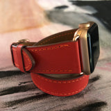 Fire Red Double Wrap Apple Watch Leather Band by Juxli Home.  Handmade, stylish leather strap with rose gold hardware on a 40mm Apple watch on a canvas with a black and gray painting.