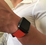 Fire Red Apple Watch Leather Band by Juxli Home.  Handmade, stylish leather strap with rose gold hardware on a 40mm Apple watch on a canvas with a black and gray painting.