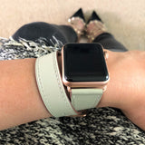 Ladies Sage Gray Double Wrap Apple Watch Leather Band by Juxli Home.  Handmade, stylish leather strap with rose gold hardware on a 40mm Apple watch on a canvas with a black and gray painting.