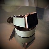 Ladies Sage Gray Double Wrap Apple Watch Leather Band by Juxli Home.  Handmade, stylish leather strap with rose gold hardware on a 40mm Apple watch on a canvas with a black and gray painting.