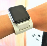 White Apple Watch Leather Cuff by Juxli Home.  Handmade, stylish leather strap with rose gold hardware on a 40mm Apple watch on a canvas with a black and gray painting.