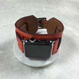 Summer Orange Apple Watch Leather Cuff by Juxli Home.  Handmade, stylish leather strap with rose gold hardware on a 40mm Apple watch on a canvas with a black and gray painting.