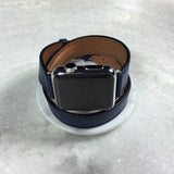 Space Blue Double Wrap Apple Watch Leather Band by Juxli Home.  Handmade, stylish leather strap with rose gold hardware on a 40mm Apple watch on a canvas with a black and gray painting.