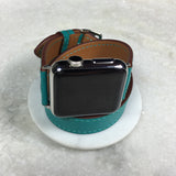 Ladies Sea Green Double Wrap Apple Watch Leather Band by Juxli Home.  Handmade, stylish leather strap with rose gold hardware on a 40mm Apple watch on a canvas with a black and gray painting.