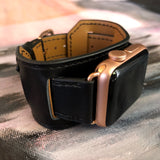 Black Apple Watch Leather Cuff by Juxli Home.  Handmade, stylish leather strap with rose gold hardware on a 40mm Apple watch on a canvas with a black and gray painting.
