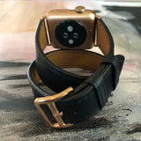Jet Black Double Wrap Apple Watch Leather Band by Juxli Home.  Handmade, stylish leather strap with rose gold hardware on a 40mm Apple watch on a canvas with a black and gray painting.
