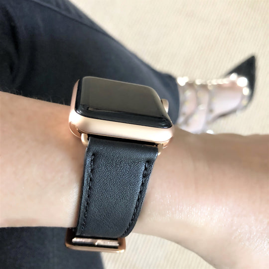 Black Apple Watch Leather Band by Juxli Home.  Handmade, stylish leather strap with rose gold hardware on a 40mm Apple watch on a canvas with a black and gray painting.