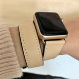 Blush Rose Double Wrap Apple Watch Leather Band for Women by Juxli Home.  Handmade, stylish leather strap with rose gold hardware on a 40mm Apple watch on a canvas with a black and gray painting.