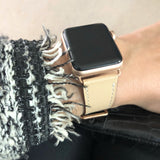 Blush Rose Apple Watch Leather Band by Juxli Home.  Handmade, stylish leather strap with rose gold hardware on a 40mm Apple watch on a canvas with a black and gray painting.