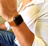 Cognac Brown Apple Watch Leather Band by Juxli Home.  Handmade, stylish leather strap with rose gold hardware on a 40mm Apple watch on a canvas with a black and gray painting.