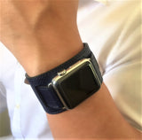 Space Blue Apple Watch Leather Cuff by Juxli Home.  Handmade, stylish leather strap with rose gold hardware on a 40mm Apple watch on a canvas with a black and gray painting.