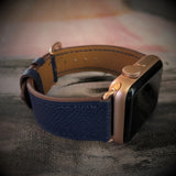 Space Blue Textured Leather Apple Watch Band by Juxli Home.  Handmade, stylish leather strap with rose gold hardware on a 40mm Apple watch on a canvas with a black and gray painting.