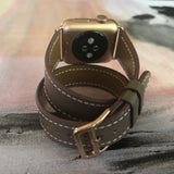 Hazel Brown Double Wrap Apple Watch Leather Band by Juxli Home.  Handmade, stylish leather strap with rose gold hardware on a 40mm Apple watch on a canvas with a black and gray painting.