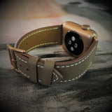 Hazel Brown Apple Watch Band by Juxli Home.  Handmade, stylish leather strap with rose gold hardware on a 40mm Apple watch on a canvas with a black and gray painting.