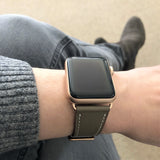 Hazel Brown Apple Watch Band by Juxli Home.  Handmade, stylish leather strap with rose gold hardware on a 40mm Apple watch on a canvas with a black and gray painting.