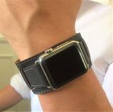 Dark Gray Apple Watch Leather Cuff by Juxli Home.  Handmade, stylish leather strap with rose gold hardware on a 40mm Apple watch on a canvas with a black and gray painting.
