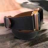 Charcoal Gray Double Wrap Apple Watch Band by Juxli Home.  Handmade, stylish leather strap with rose gold hardware on a 40mm Apple watch on a canvas with a black and gray painting.
